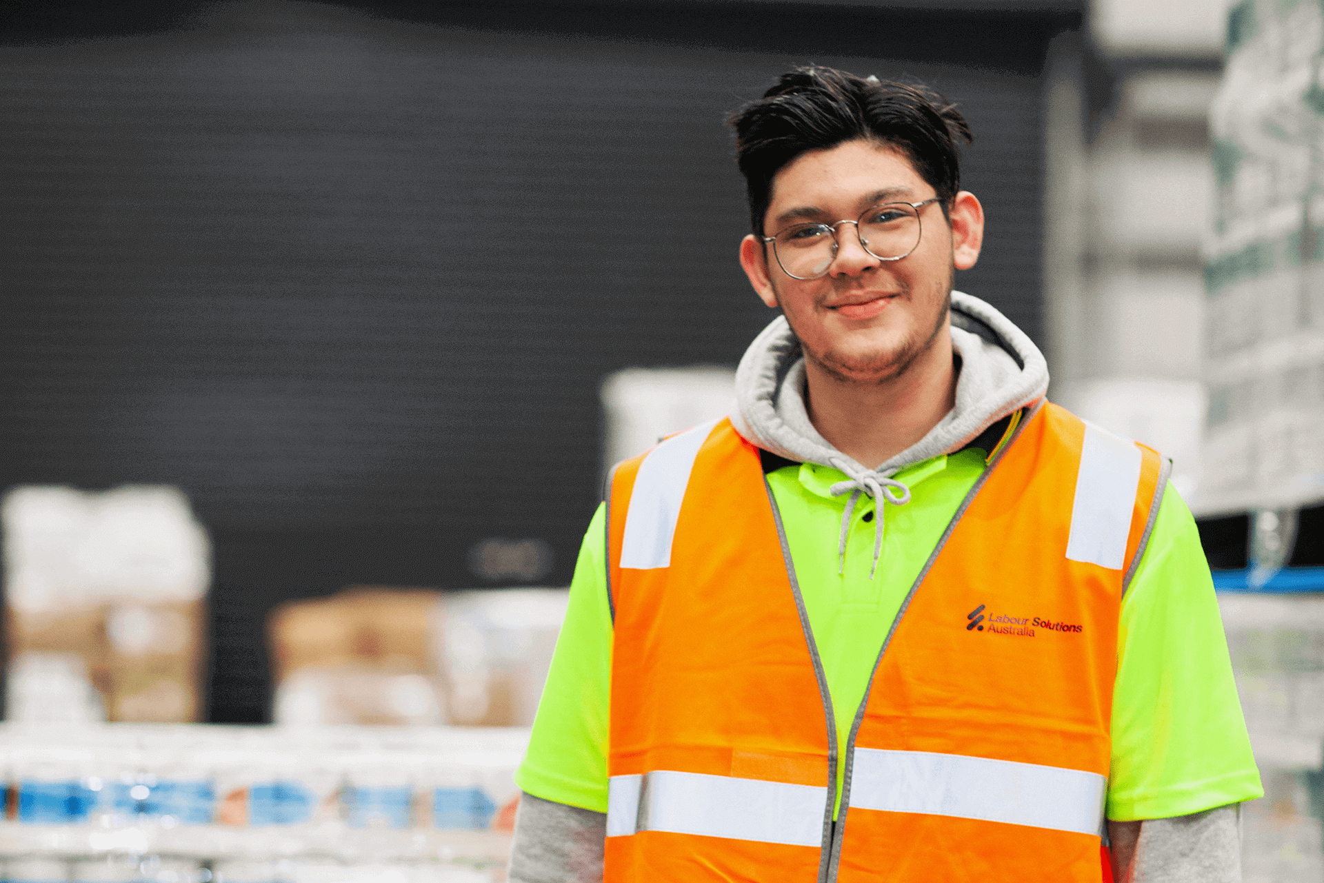 Happy Warehouse Worker Smiling at Camera