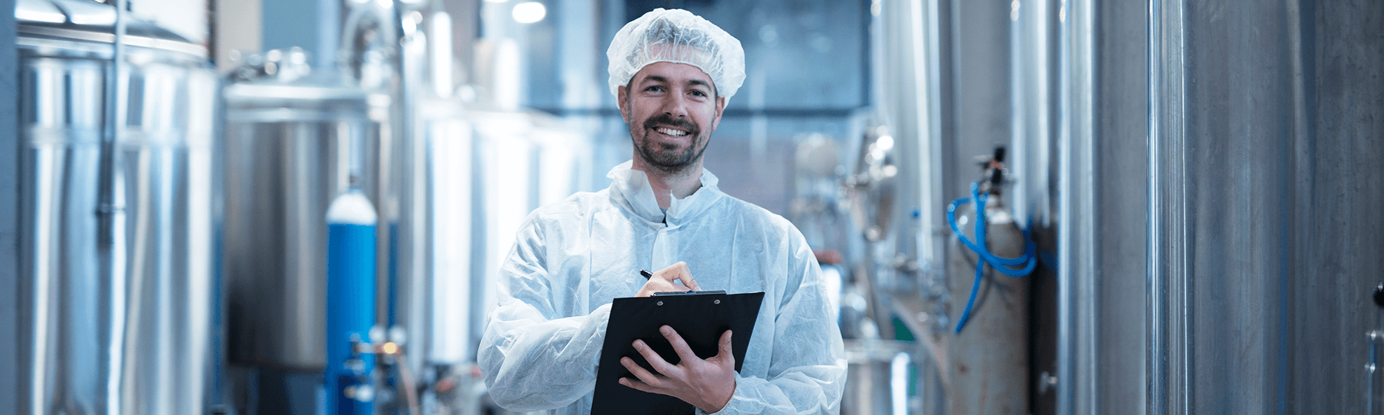 Food processing worker with clipboard