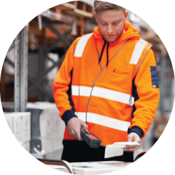 man working on logistics problems in warehouse