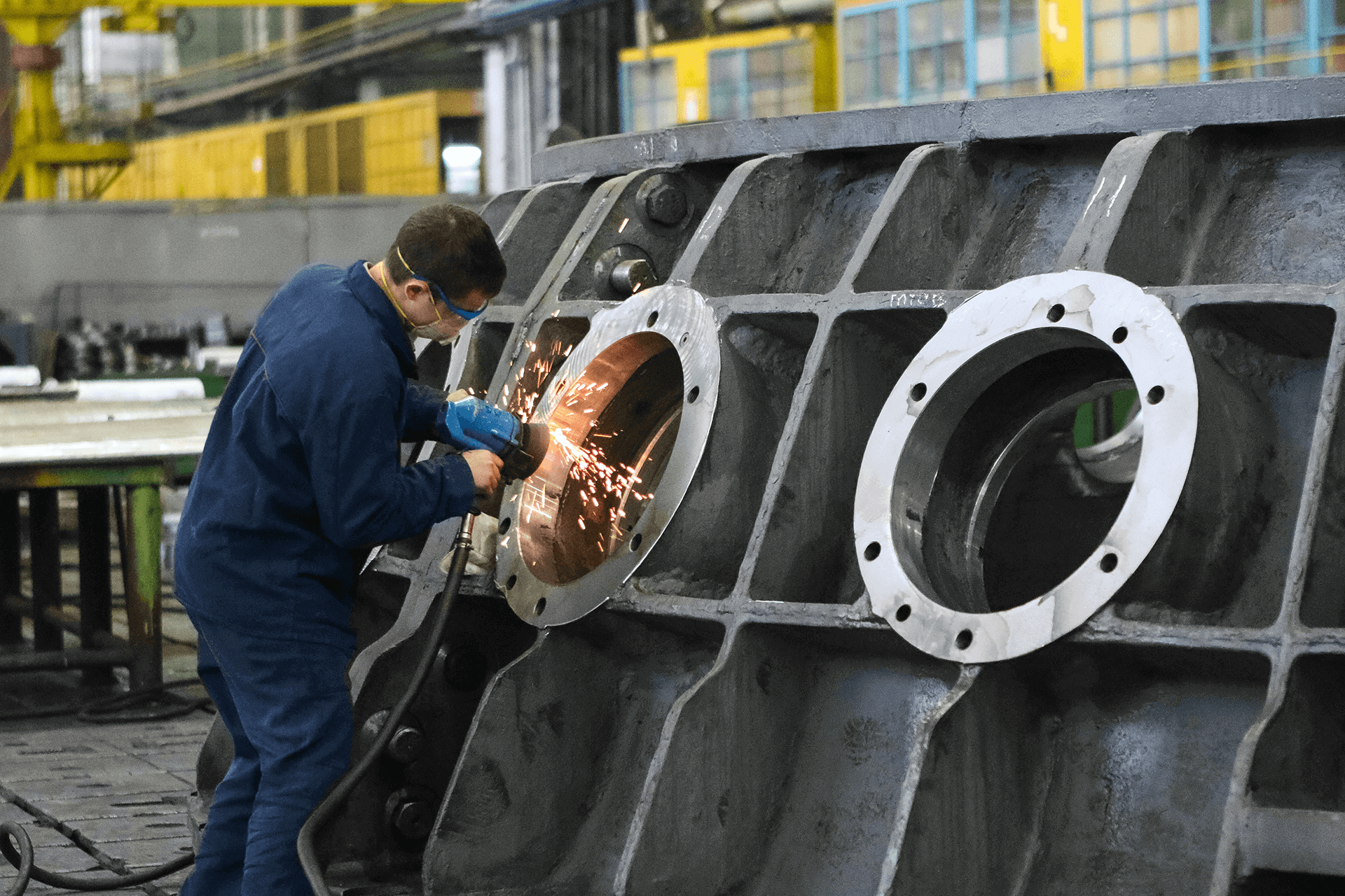 Photograph of Engineer Working on Machinery Part