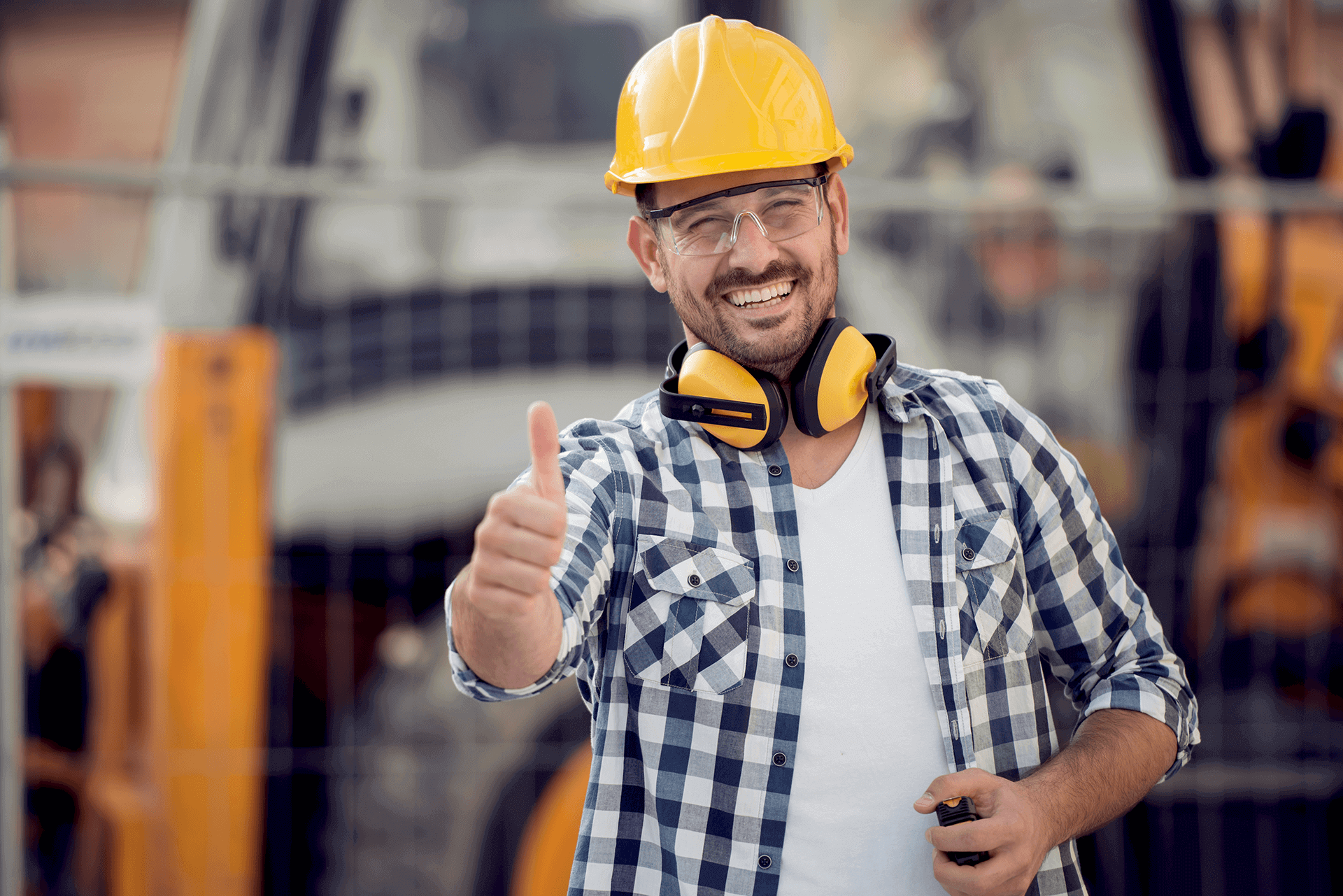 Smiling Worker Giving a Thumbs-up on a Worksite