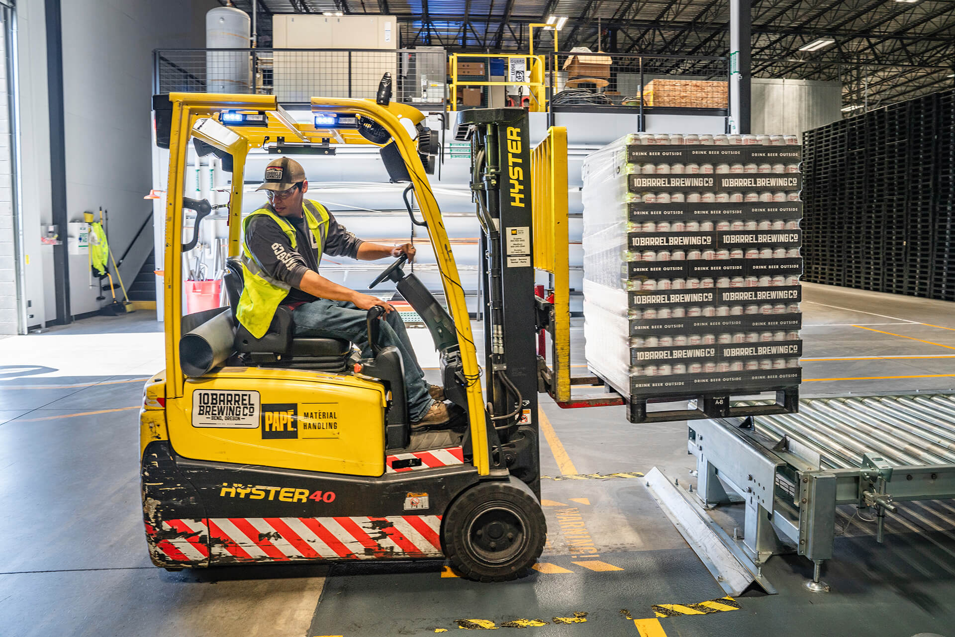 Photograph of worker operating forklift in warehouse