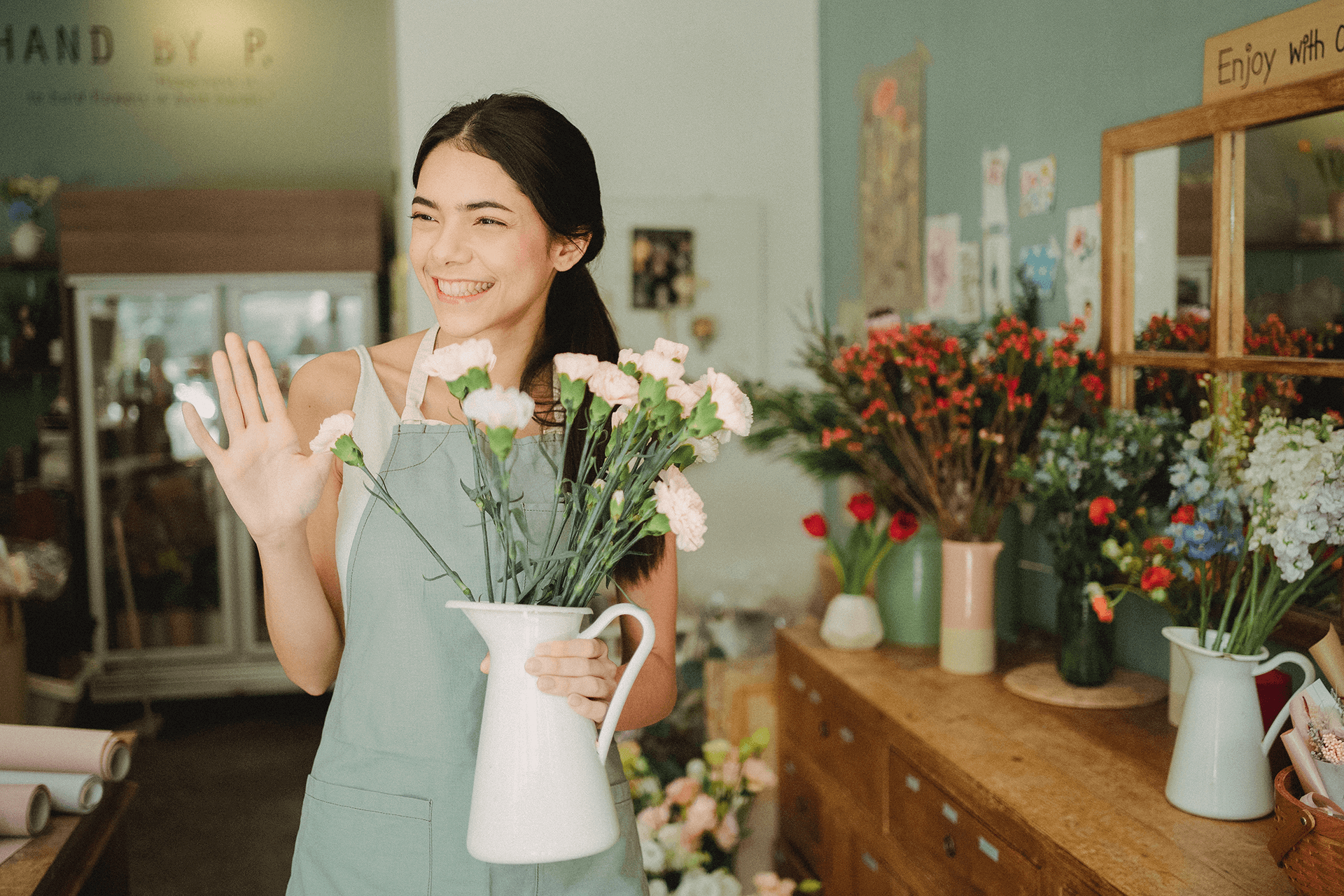 Smiling Florist Holding a Vase and Waving at a Customer