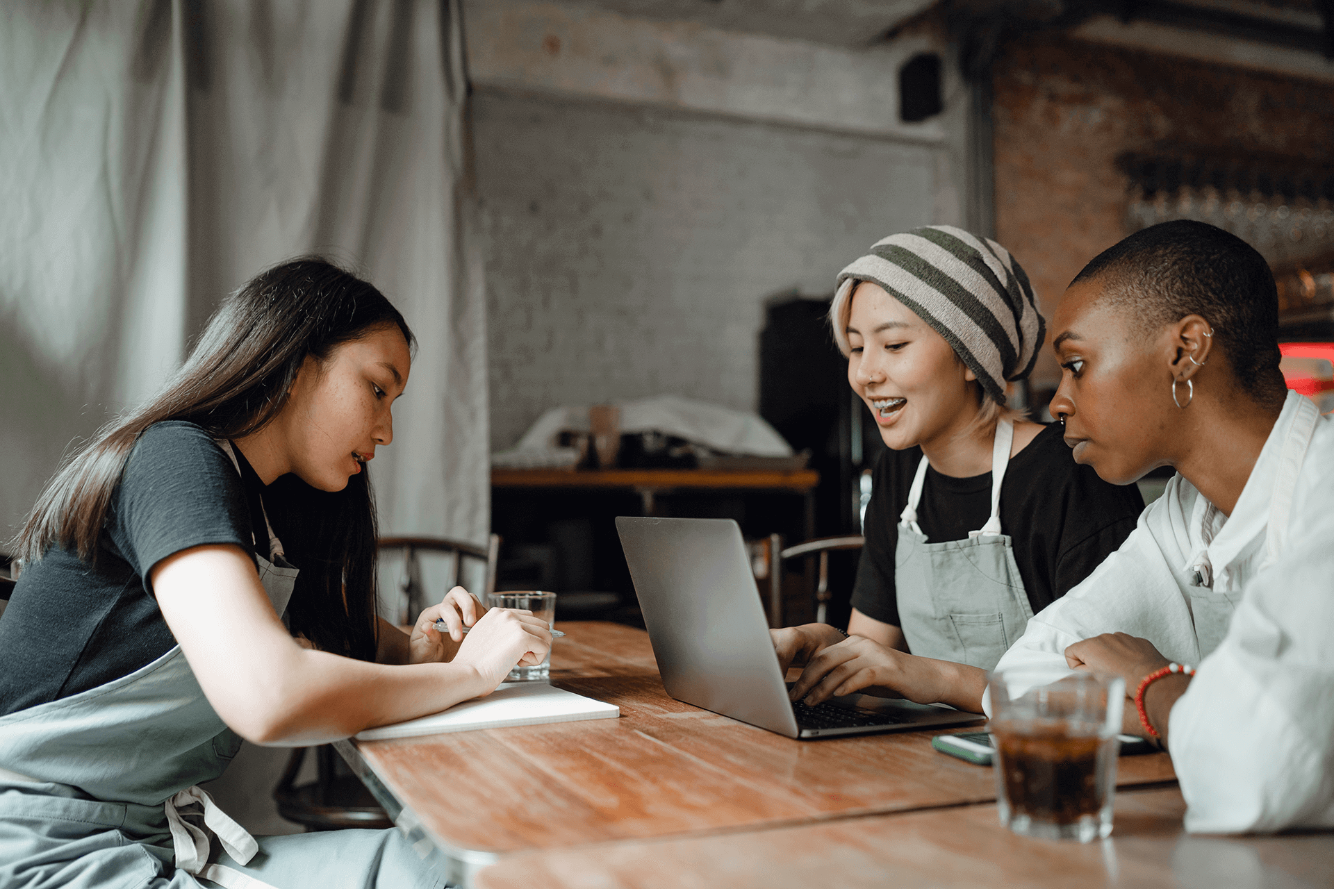 Three Female Hospitality Workers Discussing Their Work