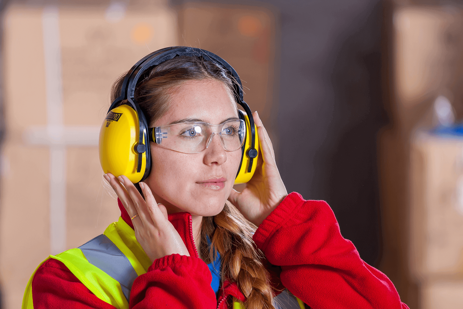 Woman in High-Vis Vest, Earmuffs and Safety Glasses